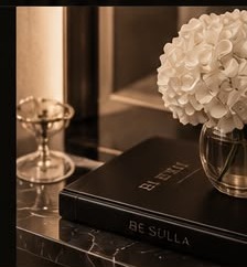 Still life of the Be Sulla book and orchid stems